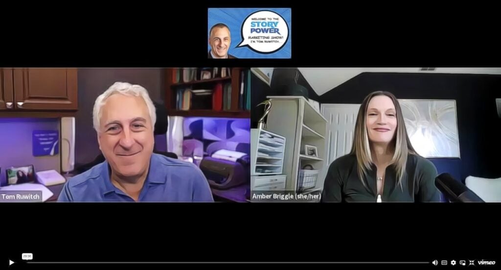A video call screenshot shows two people smiling: a man on the left in a blue shirt labeled Tom Ruwitch and a woman on the right in a dark top labeled Amber Briggle (she/her). A show logo appears above them.