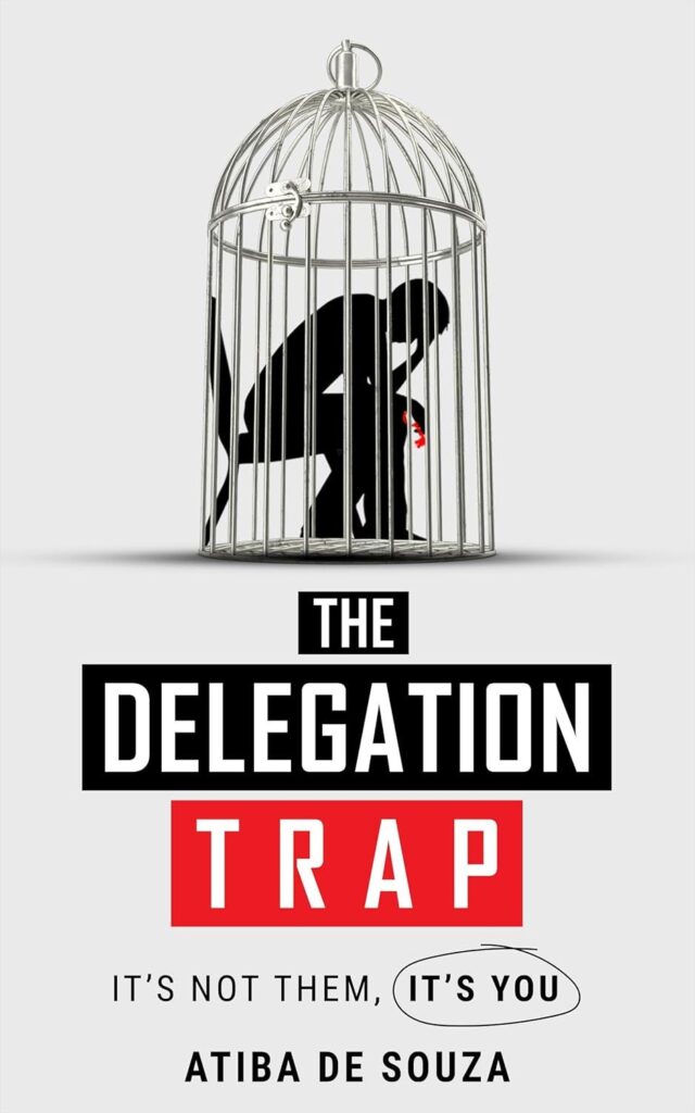 A person crouches inside a birdcage holding a red ball. Below, the book title reads The Delegation Trap with Trap in a red box. Subtitle: Its not them, its you. Author: Atiba de Souza.