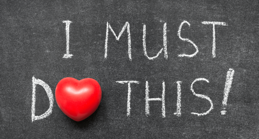 Chalkboard with the words I MUST DO THIS! written in white chalk; the letter O in DO is replaced by a red heart.