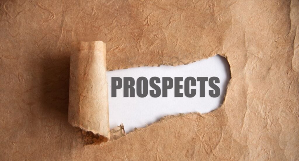 A piece of brown paper with a section torn away reveals the word PROSPECTS in bold, gray letters on a white background underneath.