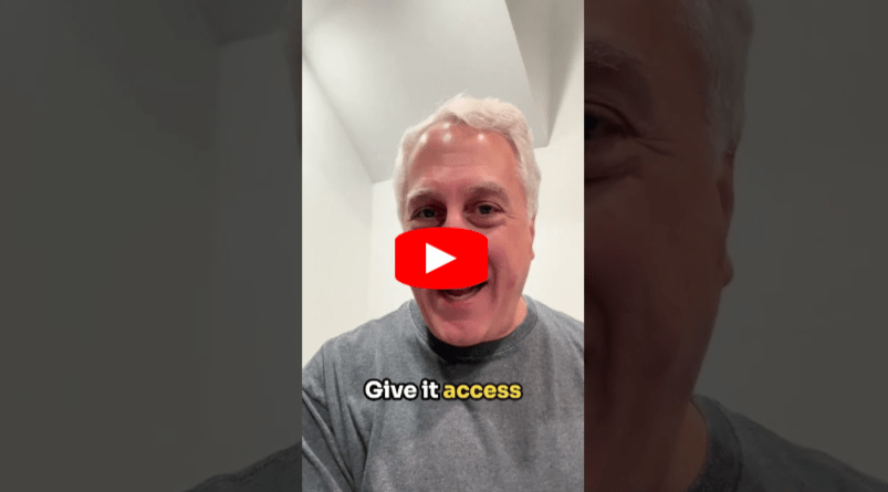 A man with gray hair and a gray shirt smiles at the camera. The text Give it access appears at the bottom in white and yellow. A play button icon is centered on the image.